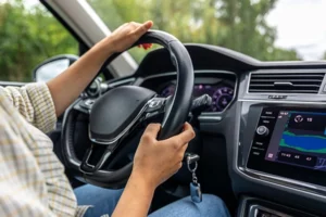 driver holding steering wheel